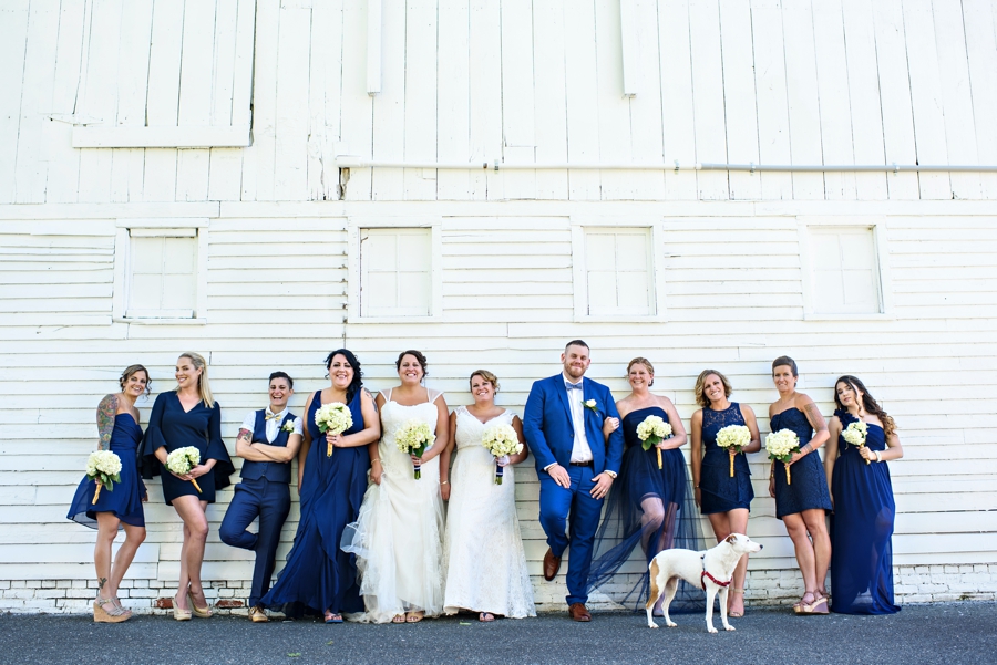 A sexy wedding party poses at a LGBTQ Wedding.